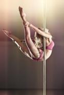 11519_10087577-young-pole-dance-woman-on-wall-background.