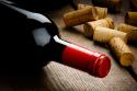 32901_shutterstock_121699039_Bottle_of_red_wine_and_corks_on_wooden_table_.